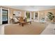 Comfortable living room features wood-paneled walls, and views of the pool at 424 Cezanne Dr, Osprey, FL 34229