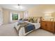 Sunny main bedroom featuring a king bed, a walk-in closet, and great natural light at 424 Cezanne Dr, Osprey, FL 34229