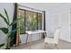 Bright office space featuring a large window, desk, chair, and a leafy green plant at 424 Cezanne Dr, Osprey, FL 34229