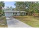 Charming single-story home features a well-manicured lawn, attached garage, and inviting curb appeal at 4363 Melis St, Port Charlotte, FL 33948