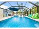 Inviting screened-in pool featuring in-pool seating, a relaxing hot tub, and comfortable lounging areas at 531 Edlee Ln, Longboat Key, FL 34228