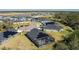 Aerial shot of homes with solar panels, a screened in pool and community amenities at 6614 162Nd E Pl, Parrish, FL 34219