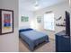 Bright bedroom featuring a ceiling fan, closet, and fun beach-themed decor at 6614 162Nd E Pl, Parrish, FL 34219