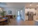 Spacious dining area with a dining table, chairs, modern decor, connecting the entryway, dining, and kitchen spaces at 6614 162Nd E Pl, Parrish, FL 34219
