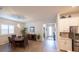 Open-concept dining area with a dining table, chairs, modern decor and seamless flow into the kitchen and entryway at 6614 162Nd E Pl, Parrish, FL 34219