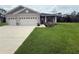 Charming home with a manicured lawn and a two-car garage at 6614 162Nd E Pl, Parrish, FL 34219