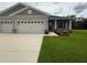 Attractive single-Gathering home boasting a three-car garage, well-maintained lawn, and inviting entrance at 6614 162Nd E Pl, Parrish, FL 34219