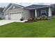 Charming single-Gathering home with a three-car garage and a beautiful landscaped yard with colorful flowers at 6614 162Nd E Pl, Parrish, FL 34219