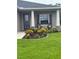 Cozy front porch featuring beautiful landscaping, inviting seating and a welcoming entrance at 6614 162Nd E Pl, Parrish, FL 34219