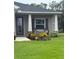 Inviting front porch with seating and professionally landscaped flower beds at 6614 162Nd E Pl, Parrish, FL 34219