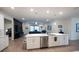 Modern kitchen featuring stainless steel appliances, a large island, and an open floor plan at 6614 162Nd E Pl, Parrish, FL 34219
