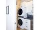 Well-organized laundry room features a stacked washer and dryer, custom cabinets, and counter space at 6614 162Nd E Pl, Parrish, FL 34219