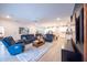 Bright open-concept living room and kitchen space features modern appliances and an entertainment center at 6614 162Nd E Pl, Parrish, FL 34219
