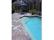 Relaxing screened-in pool featuring brick pavers, steps and lounge seating at 6614 162Nd E Pl, Parrish, FL 34219