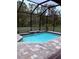 Screened-in pool featuring brick pavers, waterfall, and outdoor decor at 6614 162Nd E Pl, Parrish, FL 34219
