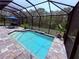 Relaxing screened-in pool featuring brick pavers, waterfall, and lounge seating at 6614 162Nd E Pl, Parrish, FL 34219