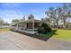 Charming home featuring a convenient carport and well-maintained landscaping under a sunny, blue sky at 703 Corsica Ct, Bradenton, FL 34207