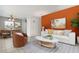 Bright living room with neutral tile floors, bold accent wall, and stylish modern furniture at 8466 Maureen Ave, North Port, FL 34287
