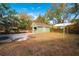 View of the backyard featuring a detached garage and mature trees at 1010 E Lake Ave, Tampa, FL 33605