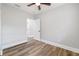 This bedroom is painted gray, features hardwood floors, and leads into another room at 1010 E Lake Ave, Tampa, FL 33605