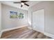 Bright bedroom featuring a ceiling fan, wood-look floors, a window, and closet at 1010 E Lake Ave, Tampa, FL 33605