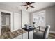 Bedroom with a ceiling fan, neutral walls, updated light fixture, and wood-look flooring at 1010 E Lake Ave, Tampa, FL 33605