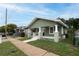 Charming home with a freshly painted exterior, a welcoming front porch, and manicured lawn at 1010 E Lake Ave, Tampa, FL 33605