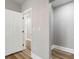 Hallway featuring neutral paint, wood-look floors, and white trim at 1010 E Lake Ave, Tampa, FL 33605