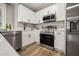 Well-equipped kitchen with stainless steel appliances, quartz countertops, and ample cabinet space at 1010 E Lake Ave, Tampa, FL 33605