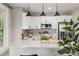 Contemporary kitchen featuring white cabinetry, stainless steel appliances, and stylish pendant lighting at 1010 E Lake Ave, Tampa, FL 33605