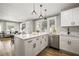 Bright, open kitchen with stainless steel appliances and an island with countertop seating at 1010 E Lake Ave, Tampa, FL 33605