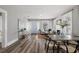 Open-concept living room features wood-look floors, lots of natural light, fireplace, and dining area at 1010 E Lake Ave, Tampa, FL 33605