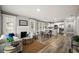 Open-concept living room featuring hardwood floors, a fireplace, and seamless flow into the modern kitchen at 1010 E Lake Ave, Tampa, FL 33605
