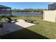 Backyard patio with two lounge chairs overlooking a beautiful serene lake at 12571 Night View Dr, Sarasota, FL 34238