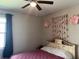 This bedroom features a ceiling fan, decorative wall art, and a window at 12571 Night View Dr, Sarasota, FL 34238