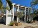 Contemporary home with clean lines, expansive windows, and a well-manicured yard and concrete patio at 3721 Flamingo Ave, Sarasota, FL 34242