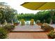 Cozy outdoor deck with chairs overlooks a serene pond surrounded by tropical foliage at 3721 Flamingo Ave, Sarasota, FL 34242