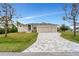 Charming one-story home with a three car garage and a brick paver driveway at 15350 Ancel Cir, Port Charlotte, FL 33981