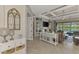 Open living room showcases stylish decor, coffered ceilings, and serene views of the pool and lake at 20686 Valprato Ct, Venice, FL 34293