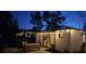 Cozy backyard at night, featuring a charming cottage-style shed with string lights at 2226 Arlington St, Sarasota, FL 34239