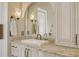Elegant bathroom featuring a white sink, granite counter, and vintage style sconce lighting at 4221 Escondito Cir, Sarasota, FL 34238