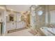 Elegant bathroom featuring double vanities, granite counters, and a glass enclosed shower with a rain shower head at 4221 Escondito Cir, Sarasota, FL 34238