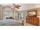 Bright bedroom with a ceiling fan, wood floors, desk, and sliding doors leading to the pool area at 4221 Escondito Cir, Sarasota, FL 34238