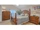 Bedroom with a nautical theme, wood floors, and a four post bed with matching night stands at 4221 Escondito Cir, Sarasota, FL 34238