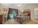 Bedroom with a four poster bed, wood floors, and sliding doors to the outdoor living space at 4221 Escondito Cir, Sarasota, FL 34238