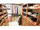 Walk-in closet featuring custom wooden built-in shelves and hanging racks for organized storage at 4221 Escondito Cir, Sarasota, FL 34238