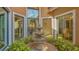 Charming courtyard with a tiered fountain surrounded by lush greenery and large windows at 4221 Escondito Cir, Sarasota, FL 34238