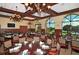 Elegant dining room with beautiful lighting fixtures, comfortable seating and views of the golf course at 4221 Escondito Cir, Sarasota, FL 34238