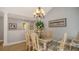 Dining room with laminate wood flooring, chandelier, and decorative artwork at 4221 Escondito Cir, Sarasota, FL 34238