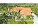 Stunning single-story home with a clay tile roof, beautiful landscaping, and a curved walkway at 4221 Escondito Cir, Sarasota, FL 34238